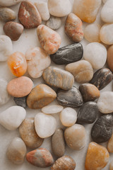 Stones and pebbles as background. Multicolor pebbles at the seaside close up view. 