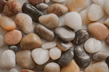 Stones and pebbles as background. Multicolor pebbles at the seaside close up view. 