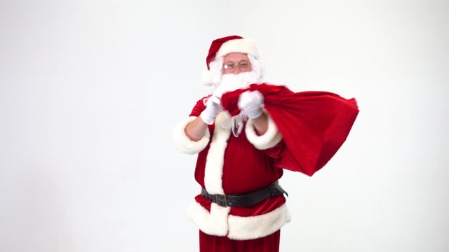Christmas. Santa Claus on a white background takes out a red box with a bow from a bag, gives it. Present. Surprise.