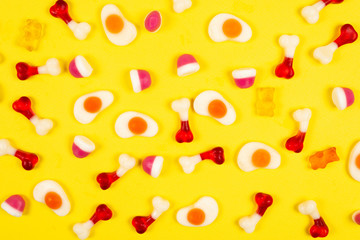 Assorted jelly sweets on yellow background. Pattern.