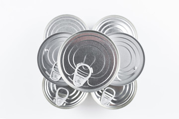 Group of silver canned food on white background.