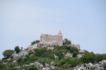 Fototapeta na wymiar ruins of an ancient fortress on top of a cliff. Kekova Turkey city ruins.