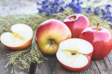 Ripe red apples on a wooden table. Vitamins and a healthy diet. Vegetarian concept.