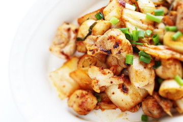Korean food, chicken and kimchi stir fried with leek