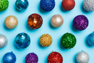 Top view of colorful Christmas balls on blue background. New Year time concept