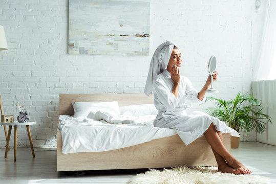 Attractive Woman In Bathrobe And Towel Looking At Mirror At Morning