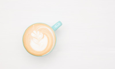 Homemade cappuccino coffee latte art on white wooden background. Copy-space for your text