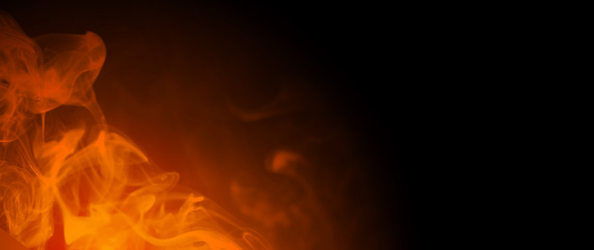 Black background with smoke and orange light for entering text for the Halloween party with copy space