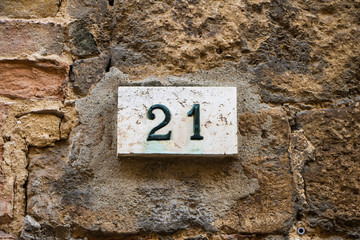 Close-Up Of Number 21 On stone wall