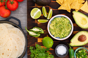 Fresh ingredients avocado, lime, cilantro, chilli with corn chips tortillas