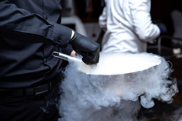 Chef is cooking ice cream with liquid nitrogen - obrazy, fototapety, plakaty