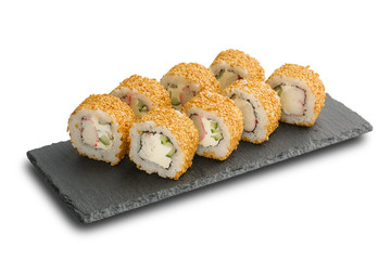 Sushi Rolls with Nishiki rice, nori, cheese, snow crab, cucumber and sesame inside on black slate or stone shale surface isolated on white background.