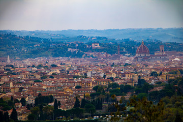 Fototapeta na wymiar Panoramic view of Florence, Tuscany region city in Italy. Red roofs and Cathedral spire. Beautiful cityscape from the top.