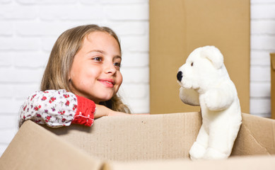 play with me. Cardboard boxes - moving to new house. happy child cardboard box. happy little girl with toy. repair of room. new apartment. purchase of new habitation