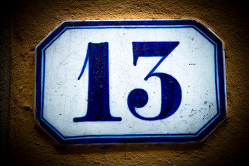 Close-Up Of Number 13 On stone wall