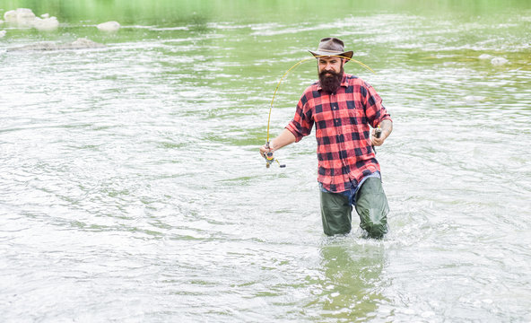 Just do that only. hobby and sport activity. fisherman show fishing technique use rod. mature man fly fishing. man catching fish. bearded fisher in water. summer weekend. Successful fly fishing