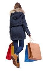 Back view of a woman in a winter jacket that comes with paper sh © ghoststone