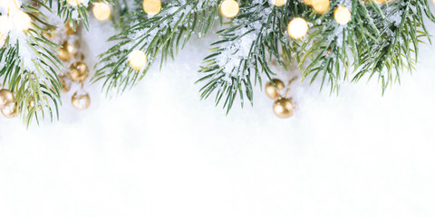 Fototapeta na wymiar Christmas and New Year snowy background. Green twigs border.