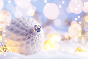 Christmas white ball with snowflakes on snow.