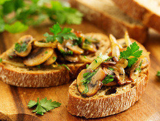Bruschetta with fried mushrooms with onions and parsley.