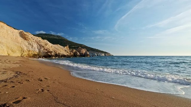 Meditative tidal waves and perfect beach at sundown. Beautiful sky and and yellow rocks and sand