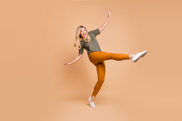 Full length body size turned photo of cheerful positive cute charming nice mature energetic woman...