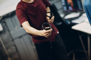 Young man in virtual reality goggles, vr glasses headset with joystick