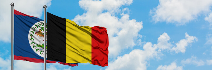 Fototapeta premium Belize and Belgium flag waving in the wind against white cloudy blue sky together. Diplomacy concept, international relations.