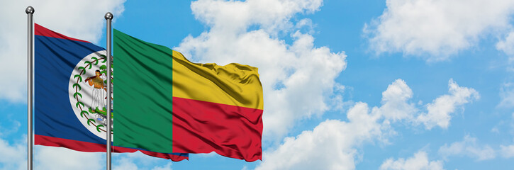 Belize and Benin flag waving in the wind against white cloudy blue sky together. Diplomacy concept, international relations.