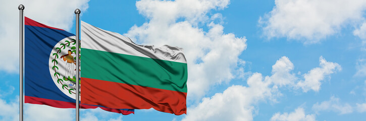 Obraz premium Belize and Bulgaria flag waving in the wind against white cloudy blue sky together. Diplomacy concept, international relations.