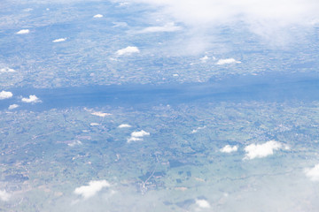 Obraz premium Clouds, sky and ground, looking from the plane.