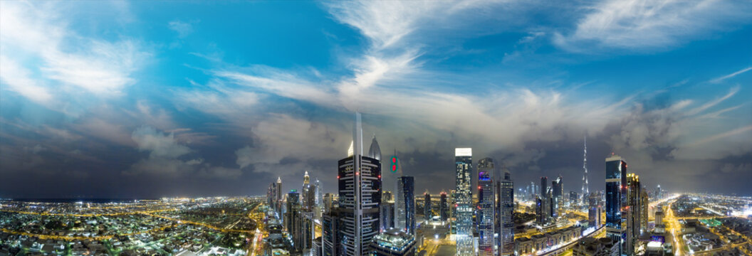 Panoramic aerial view of Dubai skyline from helicopter at sunset, United Arab Emirates © jovannig