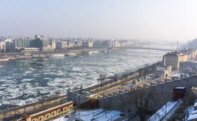 Fototapeta premium Winter time in Budapest , Hungary - touring around the city center while the Danube river is partially frozen and covered with ice! 