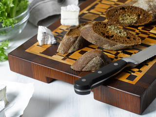 cutting board with sliced cheese