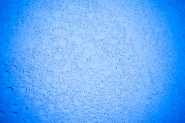 Obraz premium Rain droplets on blue glass background, Water drops on blue glass.
