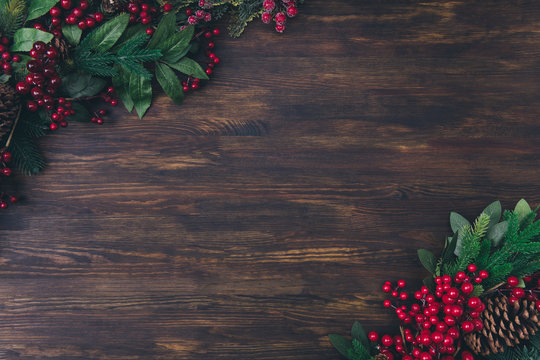 Top above high angle view photo of christmas object composition of fir tree branches berries pine cone lay on wooden brown surface background