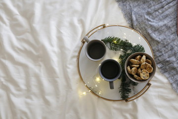  Christmas tray with two cups and cookies on the bed