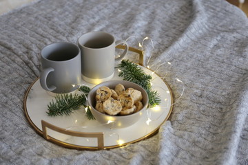 Obraz na płótnie Canvas Christmas tray with two cups and cookies on the bed