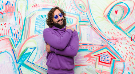 young bearded crazy man feeling in love, smiling, cuddling and hugging self, staying single, being...