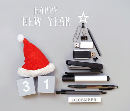 Happy New Year greeting card. symbol Christmas tree made of stationery, pens, pencils, paper clips, office supplies. new year's concept in office, University, school. Creative idea design