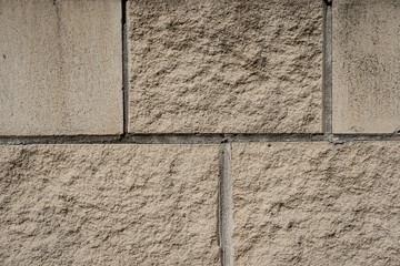 Warm, off-white sandstone wall texture.