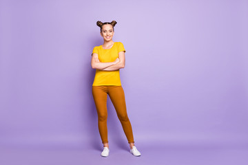 Full length photo of pretty teenager lady with crossed arms diligent student ready get education and knowledge wear yellow t-shirt trousers isolated pastel purple background