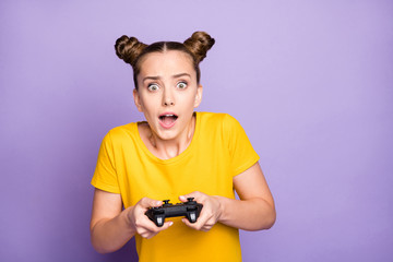 Photo of pretty lady holding joystick addicted to video games trying hard not believe it will be failure wear yellow t-shirt isolated pastel purple background © deagreez