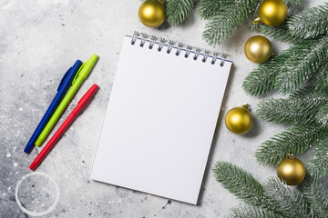 Festive Christmas background with blank Notepad and colorful pens. Top view with copy space