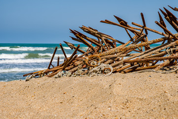 Fototapeta na wymiar Fishing anchors stacked on the beach.