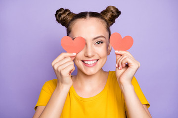 Close up photo of amazing lady holding little paper heart postcards hiding eye shy to speak with handsome guy wear yellow t-shirt isolated on pastel purple background