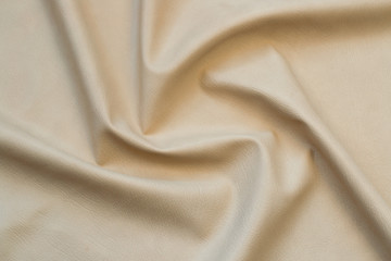 beige artificial leather with waves and folds on PVC base