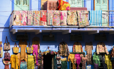 Stunning view of colorful clothes, bags and patchwork hanging outside a small shop on the streets...