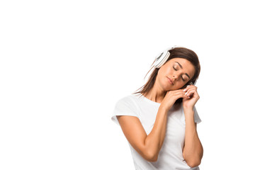 beautiful sleepy woman with closed eyes listening music with headphones, isolated on white