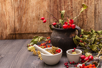 Halloween concept background. Witch bowler, mistletoe, elderberry. Dry herbs, flowers, fresh berries